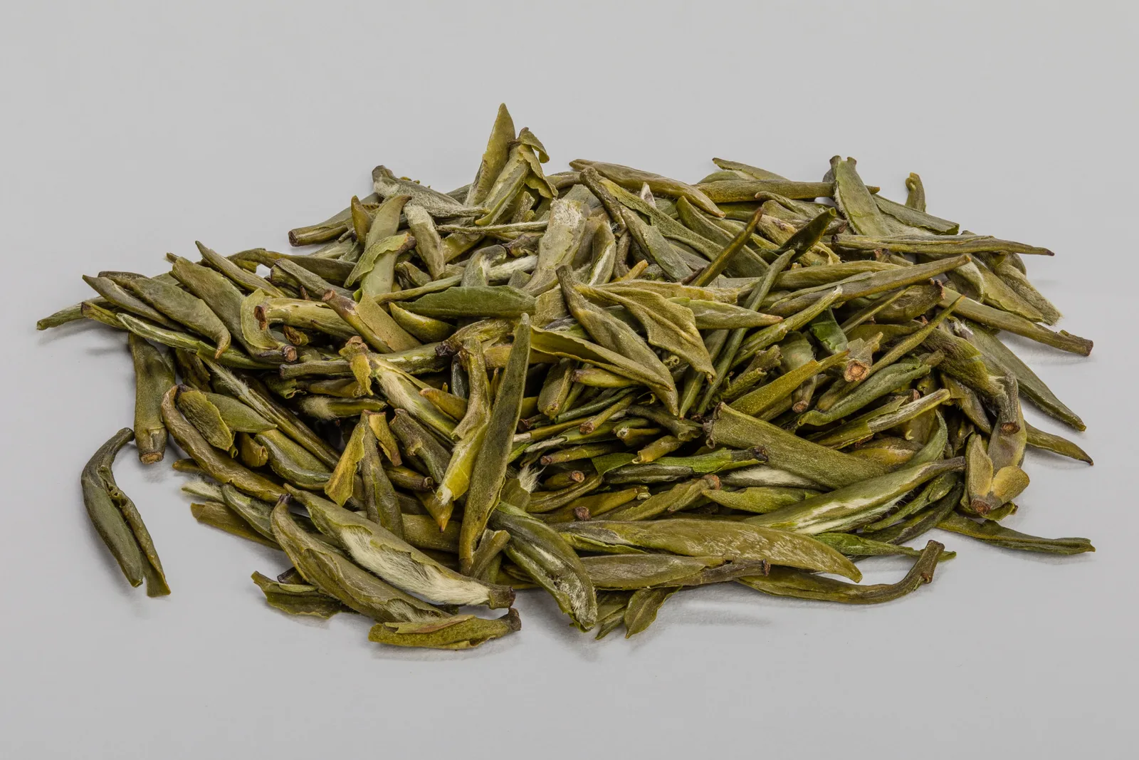 Macro photograph of dried Zhu Ye Qing green tea leaves from Sichuan, China