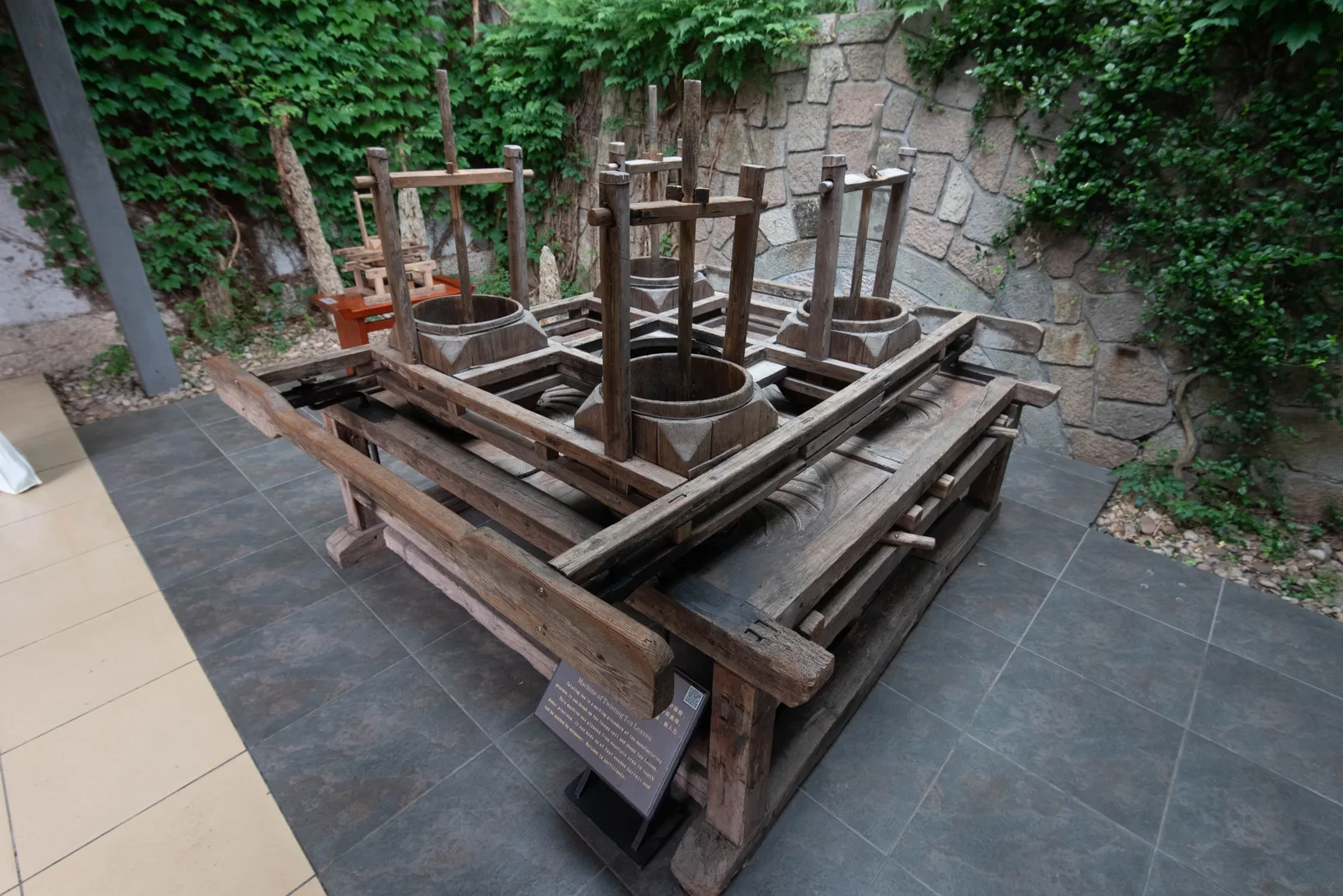 Historic four-drum tea rolling machine at the China National Tea Museum in Hangzhou